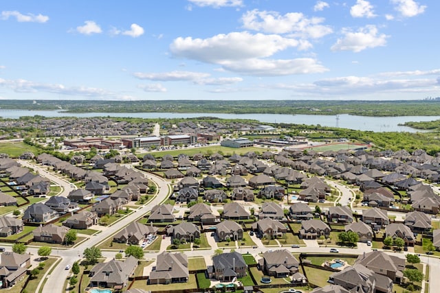 drone / aerial view with a water view and a residential view