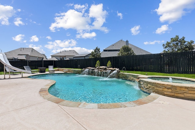 view of pool with a fenced in pool, a patio, a fenced backyard, and a water slide