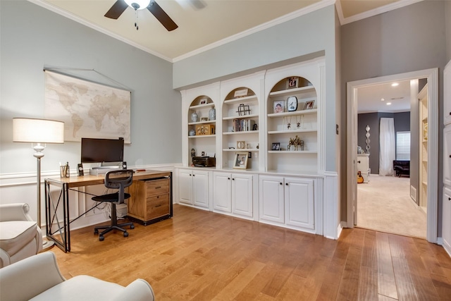 office area with crown molding, light wood-type flooring, and a ceiling fan