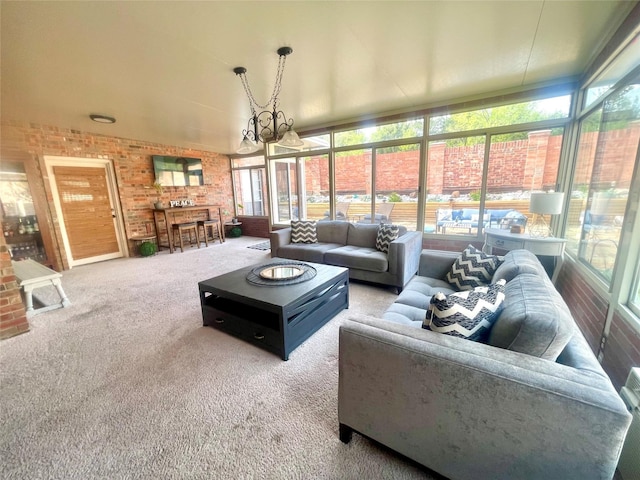 carpeted living area featuring a notable chandelier