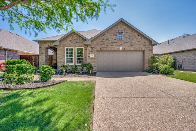 ranch-style home with concrete driveway, a garage, brick siding, and a front yard