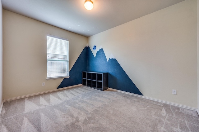 unfurnished room featuring carpet floors and baseboards