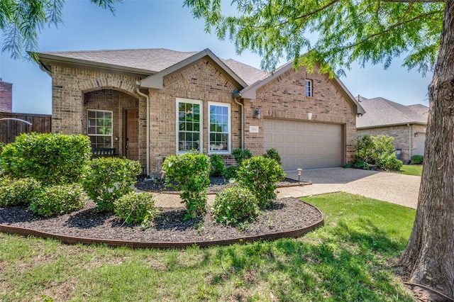 view of front of home with concrete driveway, brick siding, a front yard, and a garage