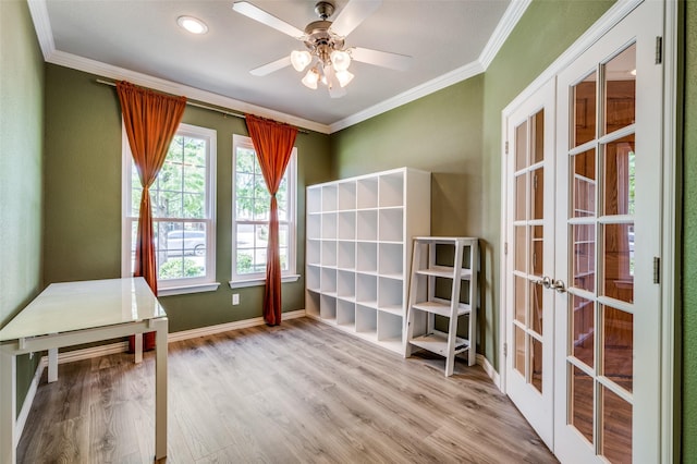 interior space featuring wood finished floors, french doors, baseboards, ceiling fan, and ornamental molding