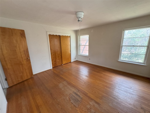 1905 Province Ln, Dallas, TX 75228 - unfurnished bedroom featuring a closet, baseboards, and wood finished floors