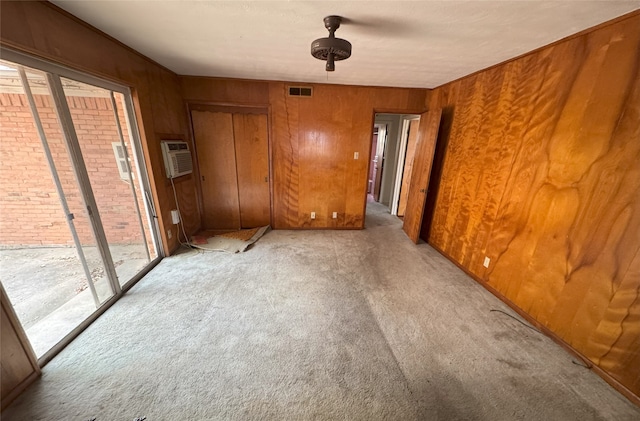 1905 Province Ln, Dallas, TX 75228 - unfurnished room with wooden walls, visible vents, carpet, and a wall unit AC