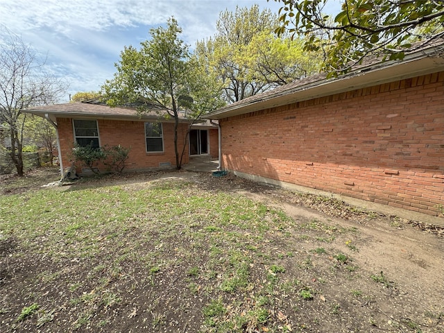 1905 Province Ln, Dallas, TX 75228 - rear view of house featuring a yard and brick siding