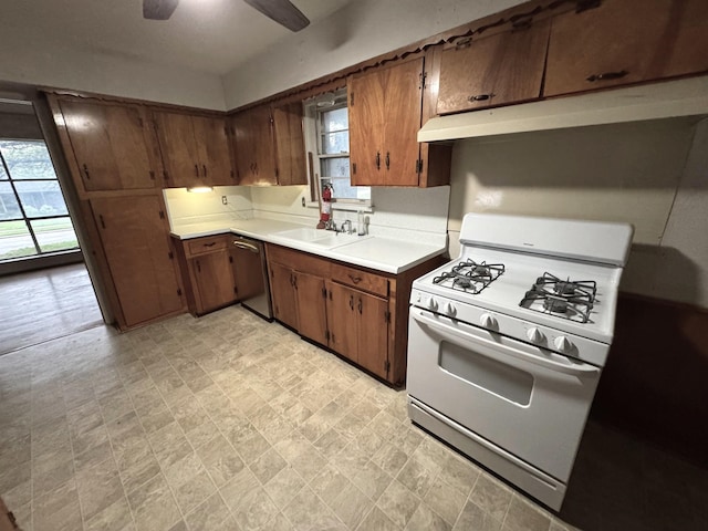 1905 Province Ln, Dallas, TX 75228 - kitchen with ceiling fan, stainless steel dishwasher, white gas stove, light countertops, and a sink