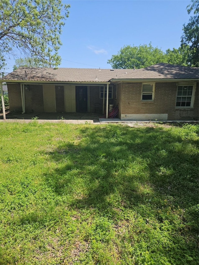 7211 Arborcrest Dr, Dallas, TX 75232 - back of property with brick siding, a patio area, and a lawn