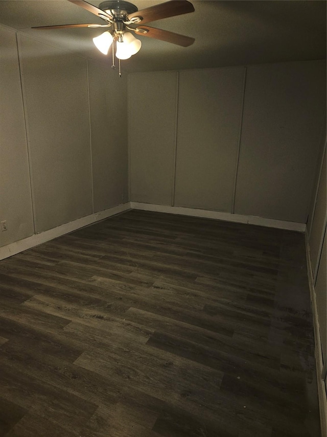 7211 Arborcrest Dr, Dallas, TX 75232 - empty room featuring a ceiling fan, a decorative wall, baseboards, and dark wood finished floors