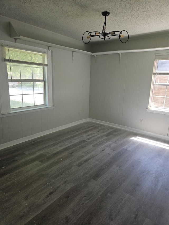 7211 Arborcrest Dr, Dallas, TX 75232 - empty room featuring a chandelier, a textured ceiling, baseboards, and wood finished floors