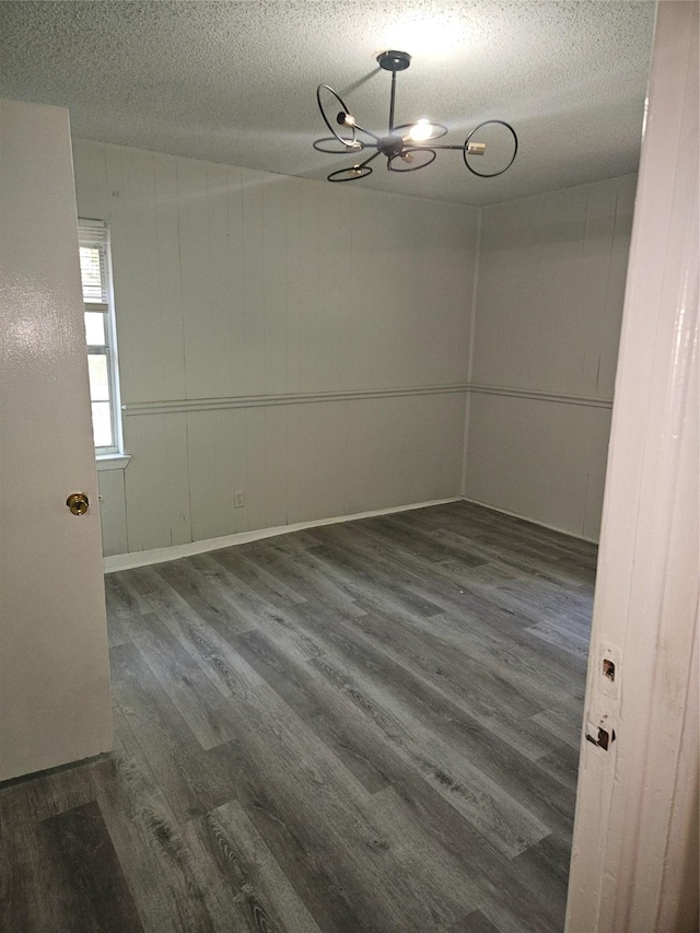 7211 Arborcrest Dr, Dallas, TX 75232 - spare room with a chandelier, a textured ceiling, and wood finished floors