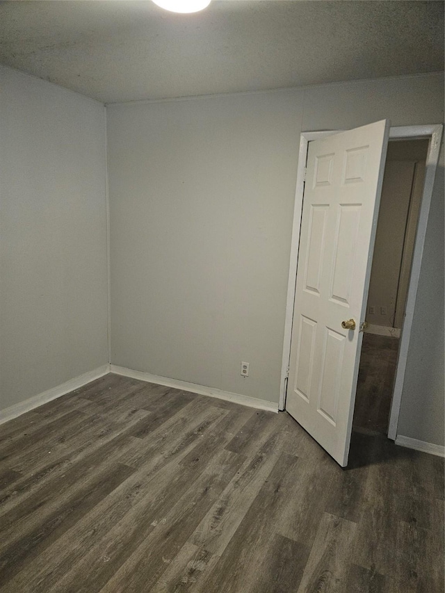 7211 Arborcrest Dr, Dallas, TX 75232 - spare room featuring baseboards and dark wood finished floors