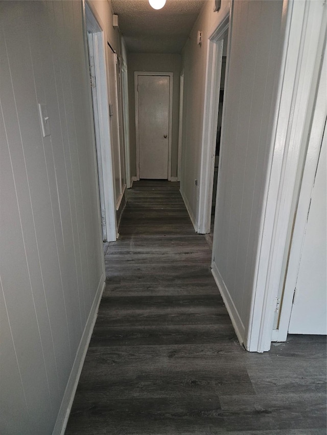 7211 Arborcrest Dr, Dallas, TX 75232 - hallway with dark wood-type flooring and baseboards