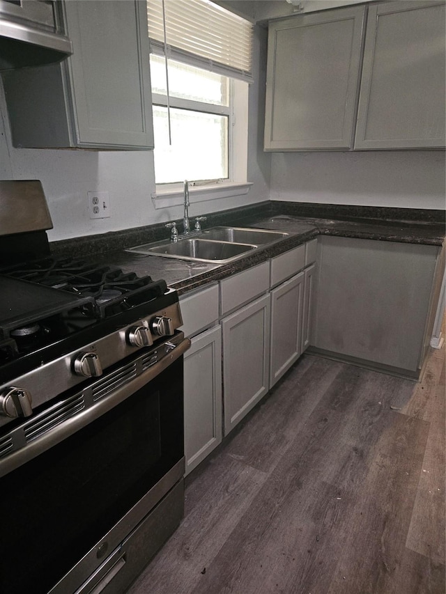 7211 Arborcrest Dr, Dallas, TX 75232 - kitchen featuring stainless steel gas range, dark countertops, extractor fan, dark wood finished floors, and a sink