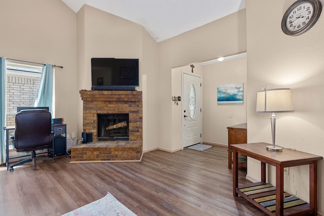 522 E Stone Cir, Wylie, TX 75098 - living room with wood finished floors, a fireplace, lofted ceiling, and baseboards