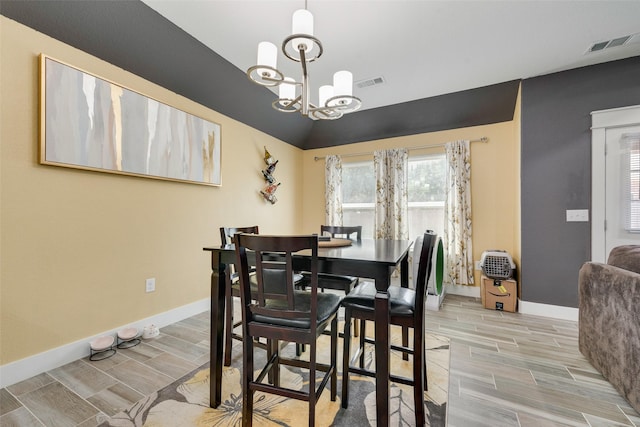dining space featuring a chandelier, visible vents, baseboards, and wood tiled floor