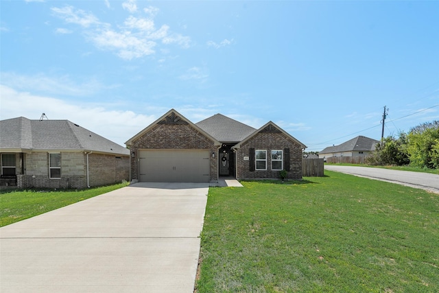 view of front of house featuring a garage, fence, brick siding, a front lawn, and driveway