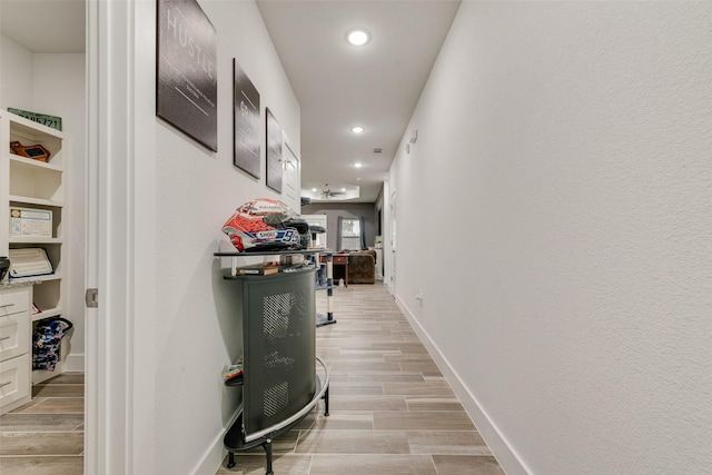 hall with recessed lighting, baseboards, and wood tiled floor