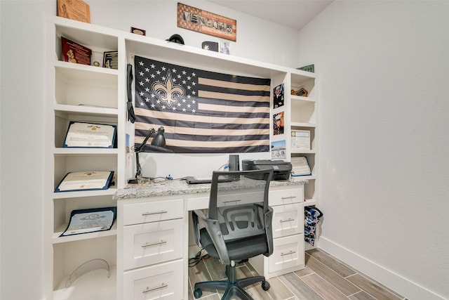 office with baseboards and light wood finished floors