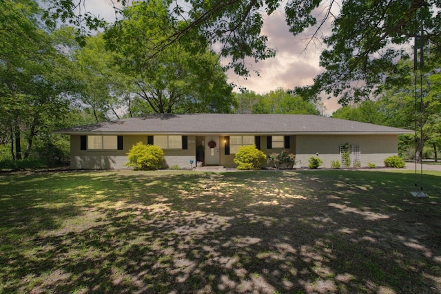 ranch-style home featuring a front yard