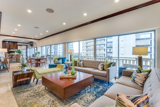 living room featuring ornamental molding and recessed lighting