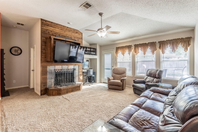 13640 Cherokee Ranch Rd, Fort Worth, TX 76262 - carpeted living room featuring healthy amount of natural light, a ceiling fan, baseboards, a stone fireplace, and vaulted ceiling