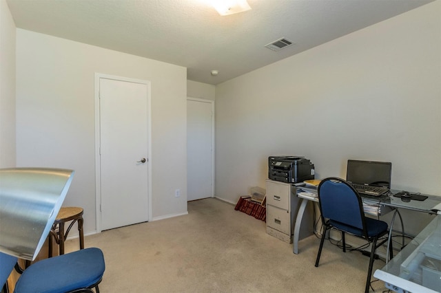 office featuring light carpet, visible vents, and baseboards