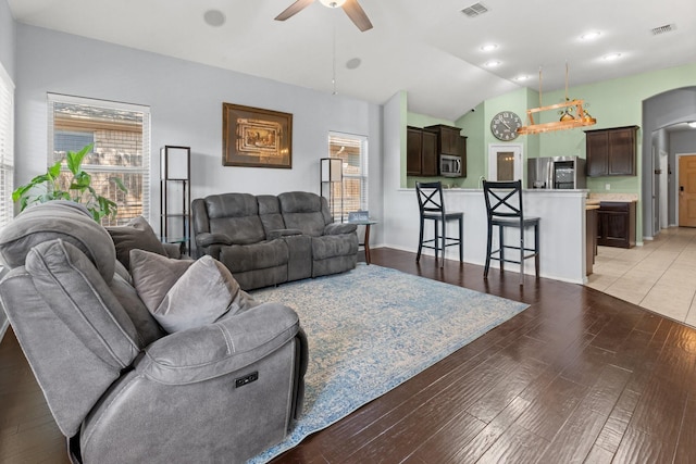 6517 Sierra Madre Dr, Fort Worth, TX 76179 - living room with visible vents, light wood-style floors, arched walkways, a ceiling fan, and vaulted ceiling