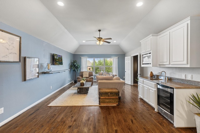 901 Moss Glen Dr, Prosper, TX 75078 - interior space featuring beverage cooler, vaulted ceiling, a ceiling fan, dark wood-type flooring, and baseboards