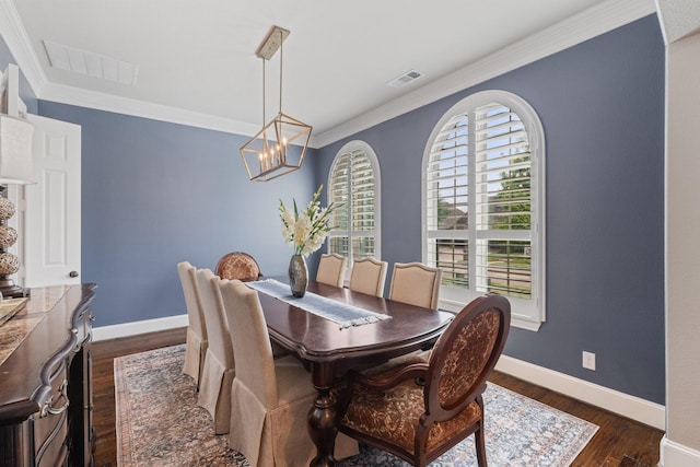 901 Moss Glen Dr, Prosper, TX 75078 - dining room with dark wood finished floors, visible vents, ornamental molding, baseboards, and a notable chandelier