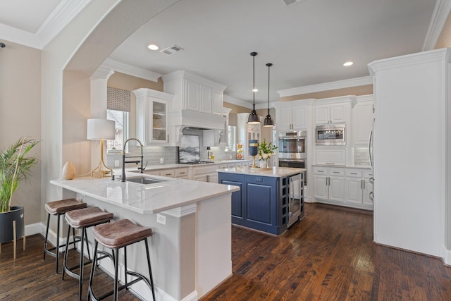901 Moss Glen Dr, Prosper, TX 75078 - kitchen with blue cabinets, white cabinets, appliances with stainless steel finishes, and visible vents