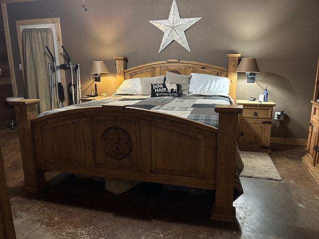 bedroom featuring finished concrete flooring and baseboards