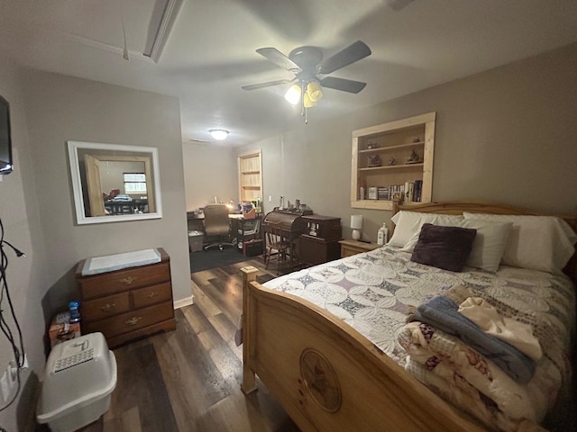 bedroom featuring attic access, ceiling fan, and dark wood-style flooring