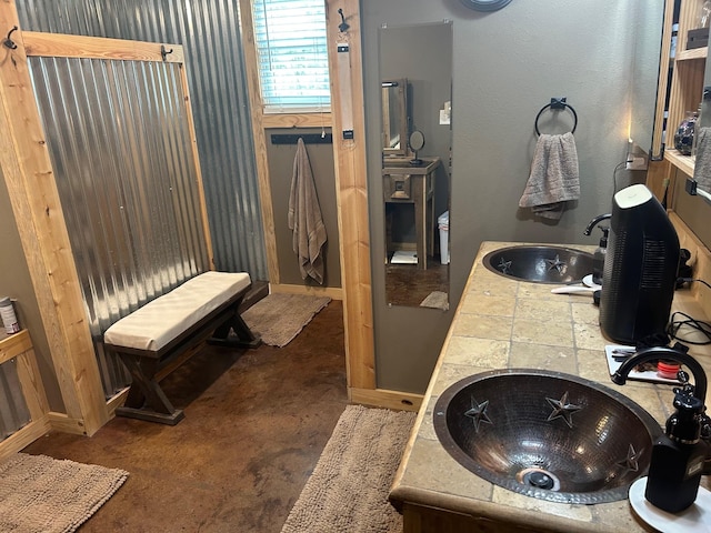999 Hayden Hall Rd, Bells, TX 75414 - bathroom featuring a sink, baseboards, and concrete flooring