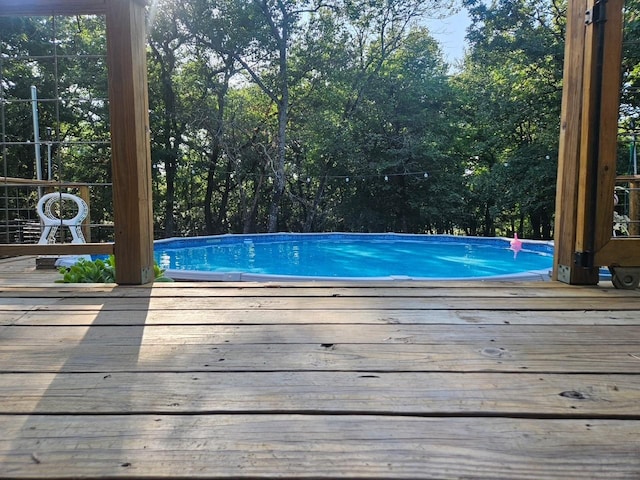 999 Hayden Hall Rd, Bells, TX 75414 - outdoor pool featuring a wooden deck and view of wooded area