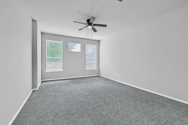 spare room featuring baseboards, a ceiling fan, and carpet flooring