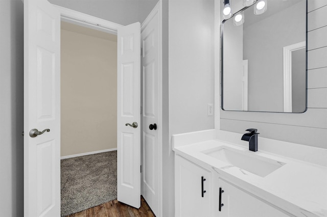 bathroom with wood finished floors and vanity