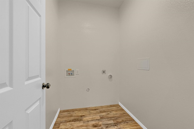 washroom featuring washer hookup, electric dryer hookup, baseboards, wood finished floors, and laundry area
