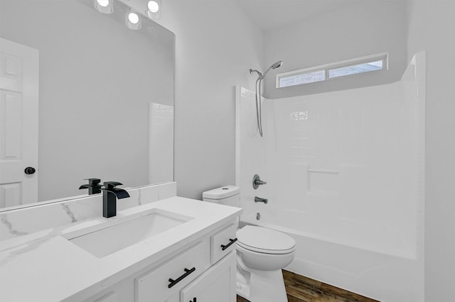 full bath with wood finished floors, toilet, shower / bathtub combination, and vanity