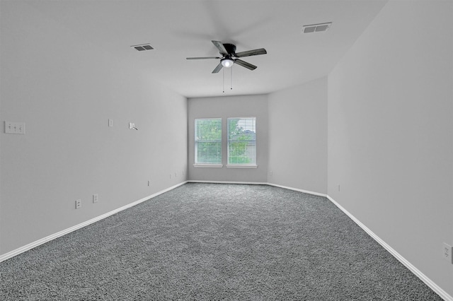 unfurnished room featuring baseboards, visible vents, a ceiling fan, and carpet