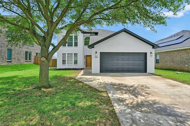 view of front of property with brick siding, fence, driveway, a front lawn, and an attached garage