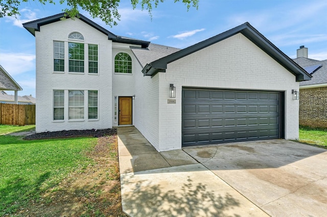traditional-style home featuring brick siding, fence, a front lawn, concrete driveway, and an attached garage