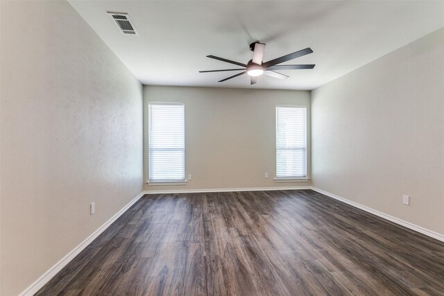 carpeted spare room featuring ceiling fan and baseboards