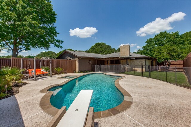 view of swimming pool with a fenced in pool, a patio, a fenced backyard, and an in ground hot tub