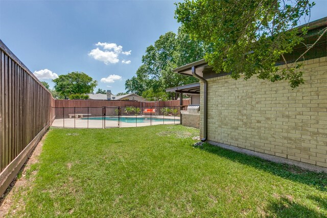 view of yard with a fenced backyard and a fenced in pool