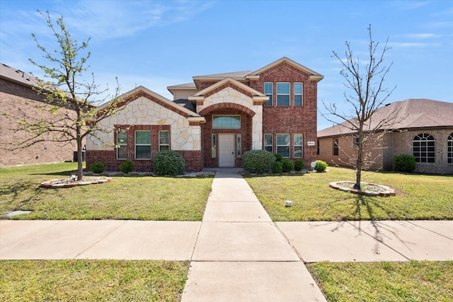 traditional-style home with stone siding, a front lawn, and brick siding