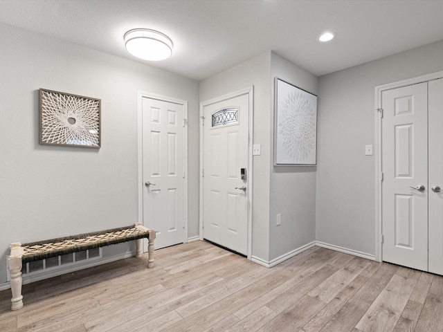 entrance foyer with recessed lighting, baseboards, and light wood finished floors