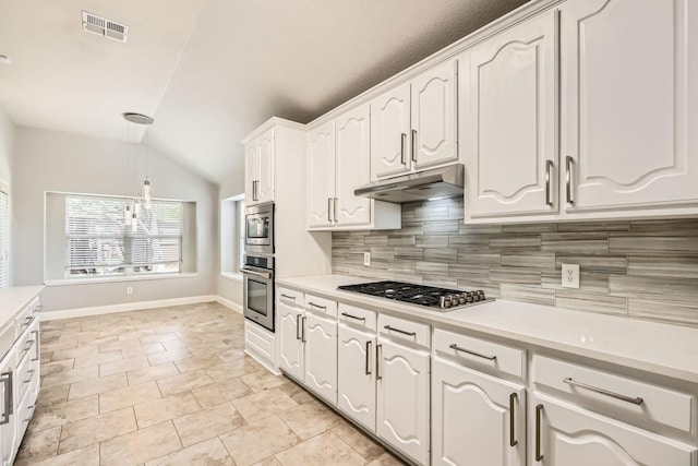 kitchen featuring appliances with stainless steel finishes, backsplash, lofted ceiling, under cabinet range hood, and visible vents