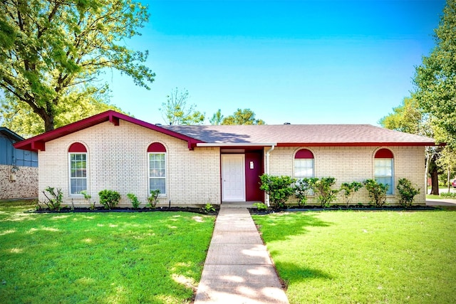 ranch-style house with a front lawn and brick siding